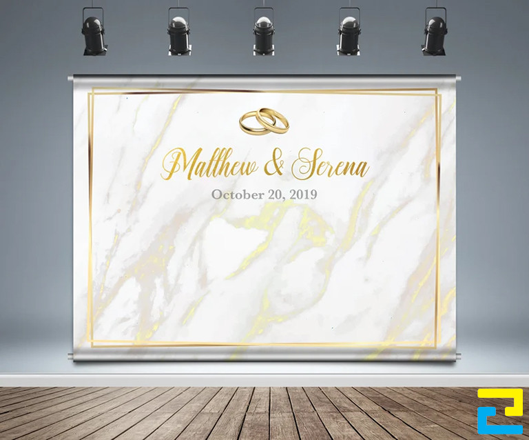 Mẫu 11: Background đám cưới ngoài trời được thiết kế đơn giản, có tông màu trắng chủ đạo, có hình ảnh cặp nhẫn cưới minh họa