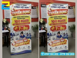 Mẫu standee tuyển dụng in bạt PP đục lỗ khoen 4 góc căng trên khung chân chữ X